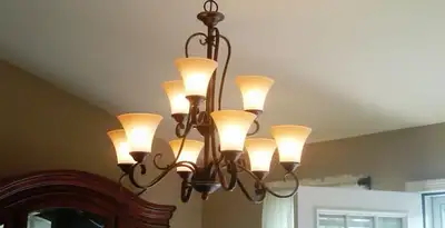 Classic ceiling chandelier installation with warm lighting in Arlington, TX