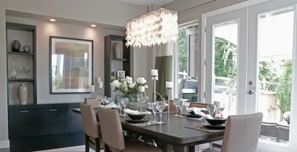 Elegant dining room chandelier installation above table in Arlington, TX