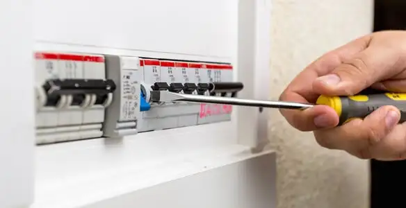 electrical panel upgrade service showing technician adjusting circuit breakers during system upgrade in Arlington, TX