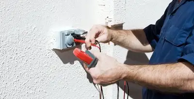 Electrician performing home electrical outlet and wiring inspection in Arlington, TX