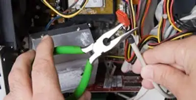 Licensed electrical contractor performing electrical repair with tools in Grand Prairie, TX