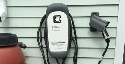 Outdoor electric vehicle charger installation on residential wall in Arlington, TX