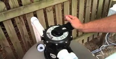 pool pumps service showing professional adjustment of pool pump control system in Arlington, TX